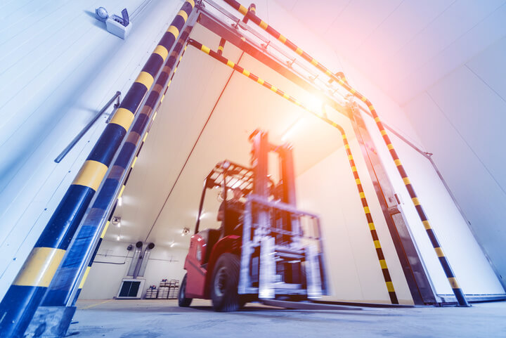 Forklift Operator In Industrial Freezer Warehouse