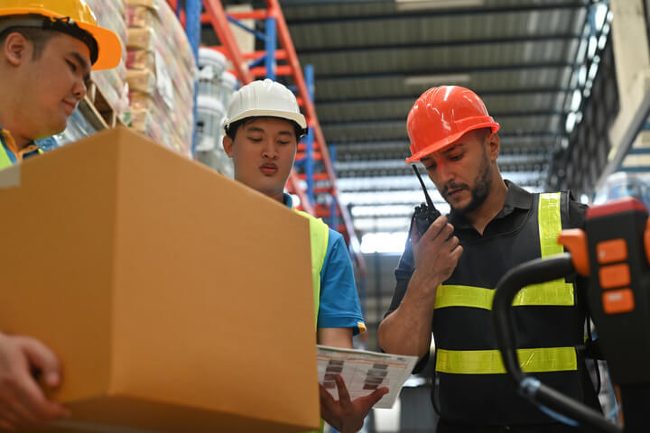 Warehouse Workers Using Walkie Talkie