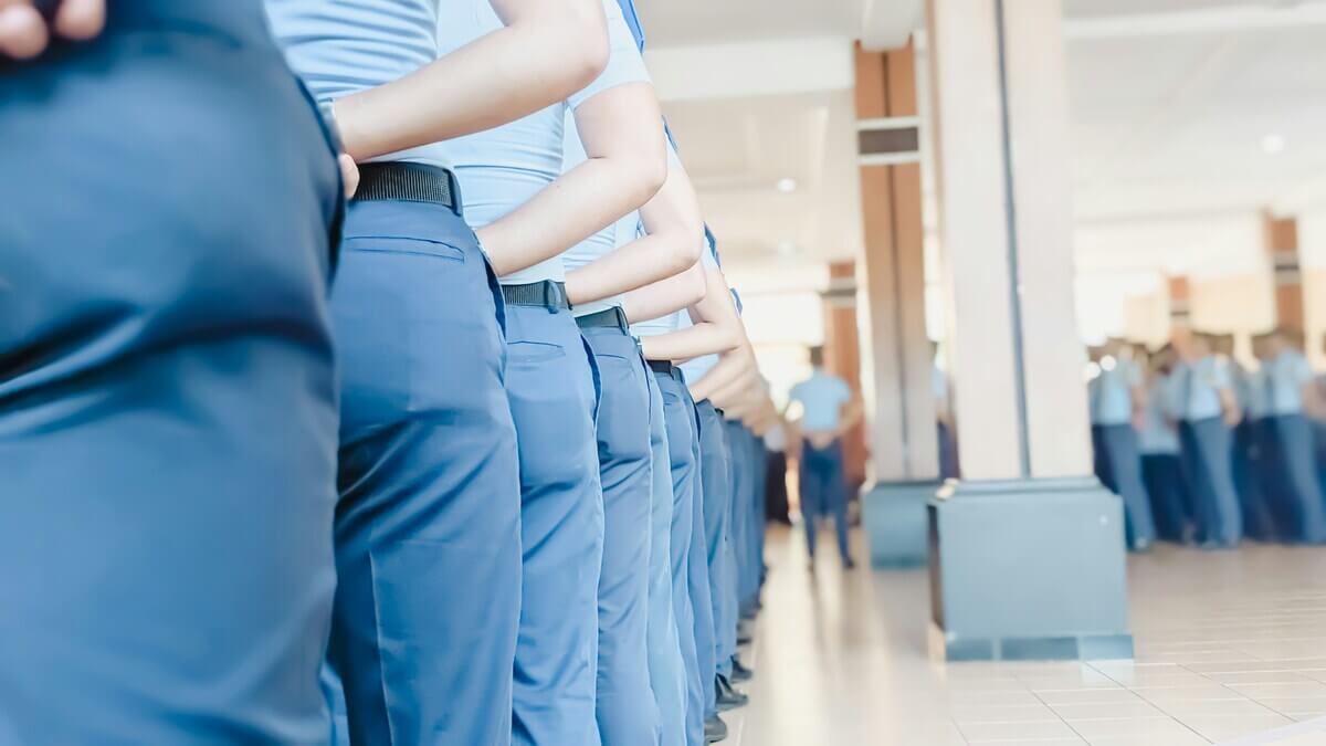 Group of employees in matching blue corporate uniforms demonstrating the scale of a managed uniform program via Get WorkGear.